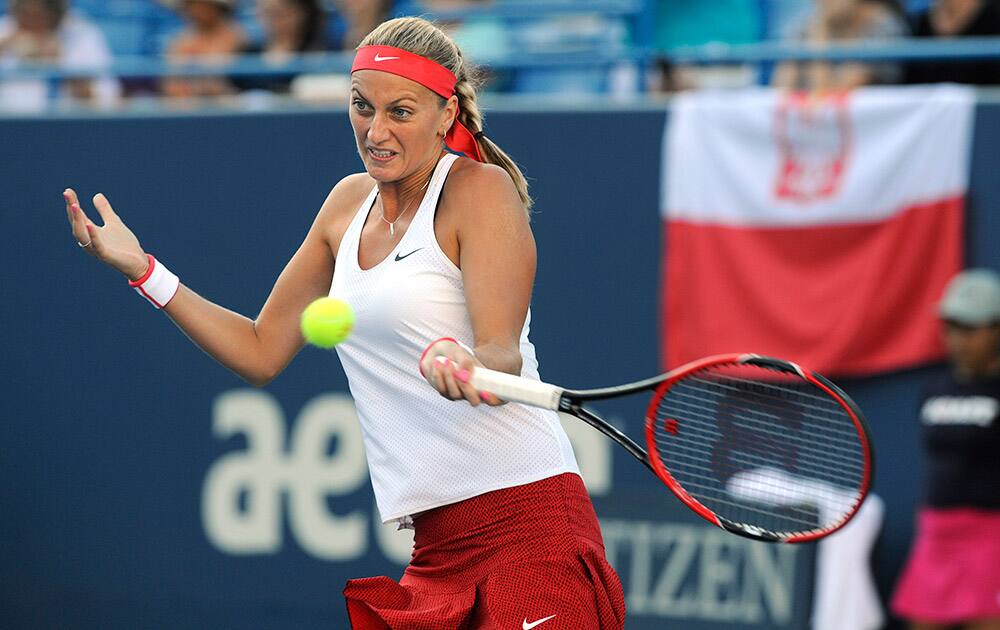 Petra Kvitova, of the Czech Republic, hits a forehand during her match against Agnieszka Radwanska, of Poland, during the quarterfinals of the Connecticut Open tennis tournament in New Haven, Conn.