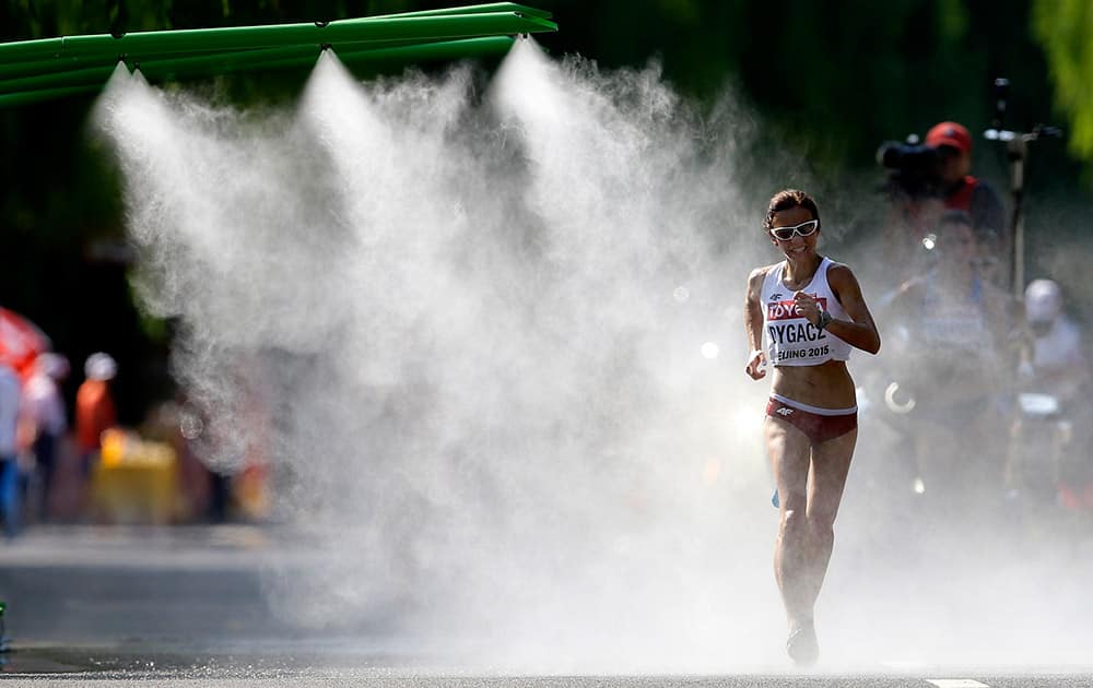 Poland's Agnieszka Dygacz walks through a cooling mist shower as she competes in the women's 20k race walk at the World Athletics Championships in Beijing.