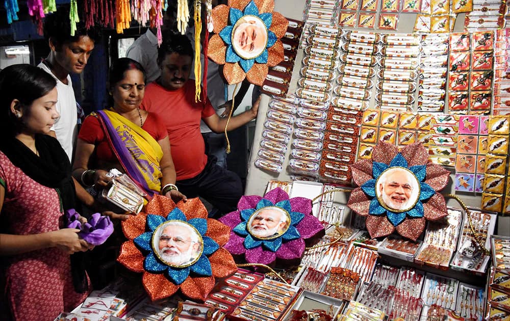 Women buying Rakhi with picture of PM Narendra Modi at shop in Patna.