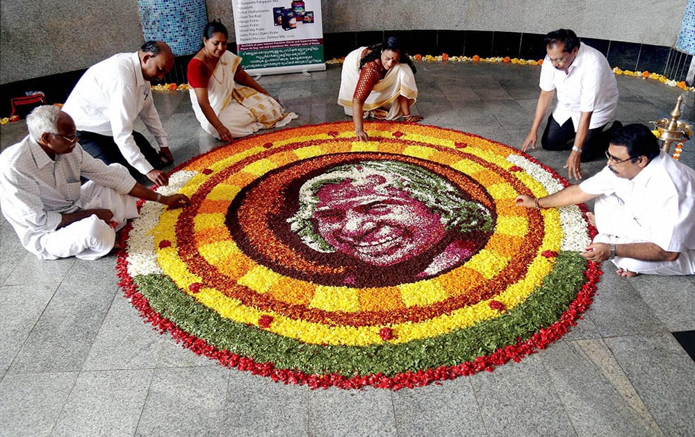 People pay tribute to former President the late APJ Abdul Kalam as they make a floral rangoli ‘pookalam’ to celebrate Onam festival in Thane, Mumbai.