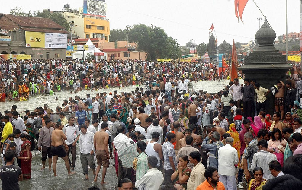Devotees taking bath in Godavari river on the occassion of Shravan Purnima during the Kumbh Mela in Nashik.