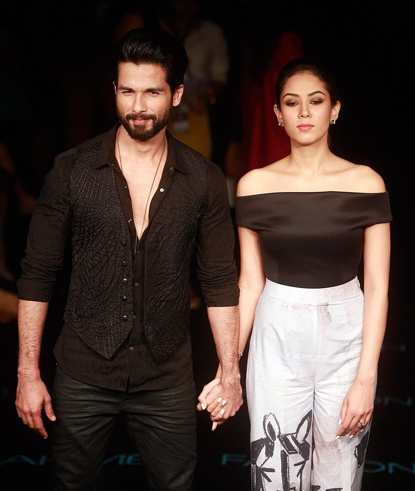 Bollywood actor Shahid Kapoor with wife Mira Rajput poses for photographs during the Lakme Fashion Week in Mumbai.