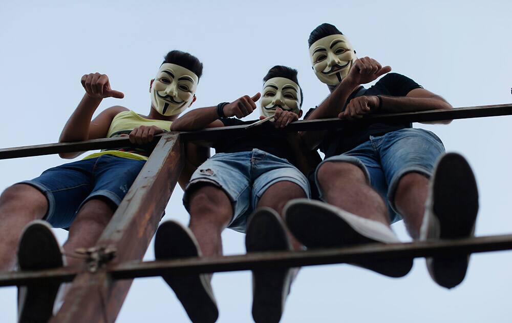 Lebanese anti-government protesters react during a demonstration against the on-going trash crisis and government corruption, in downtown Beirut, Lebanon.