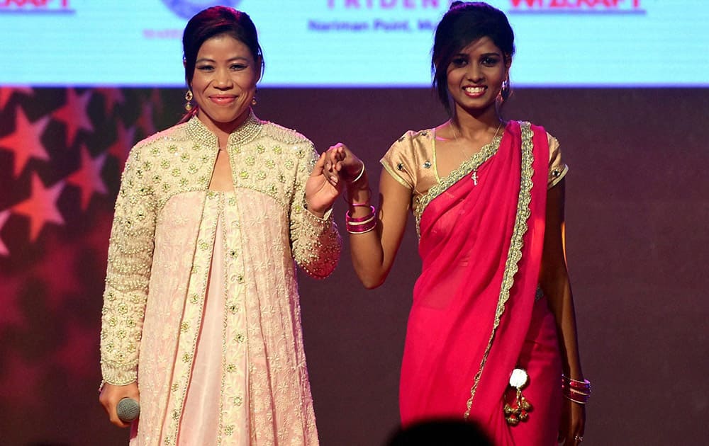 Olympian, Mary Kom with a beneficiary of the cause during a event to spread awareness against human trafficking in Mumbai.