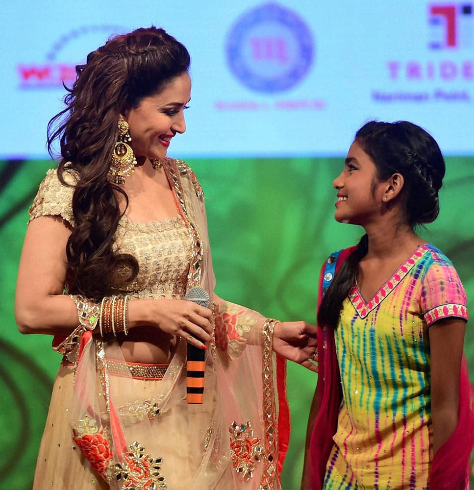 Actress Madhuri Dixit along with a beneficiary of the cause during a event to spread awareness against human trafficking in Mumbai.