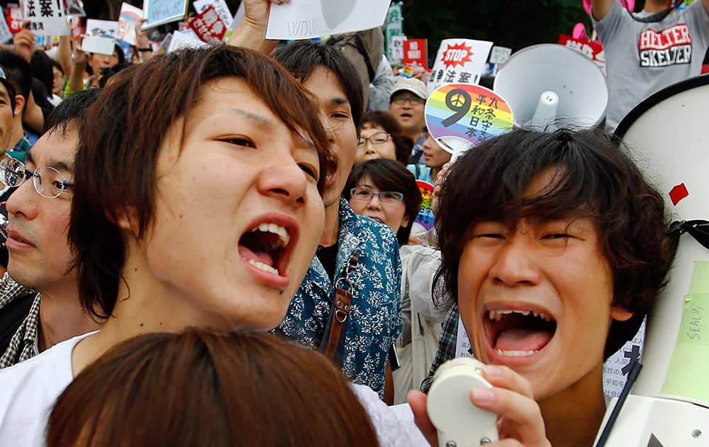 Protesters shout slogans during a rally in front of the National Diet building in Tokyo.