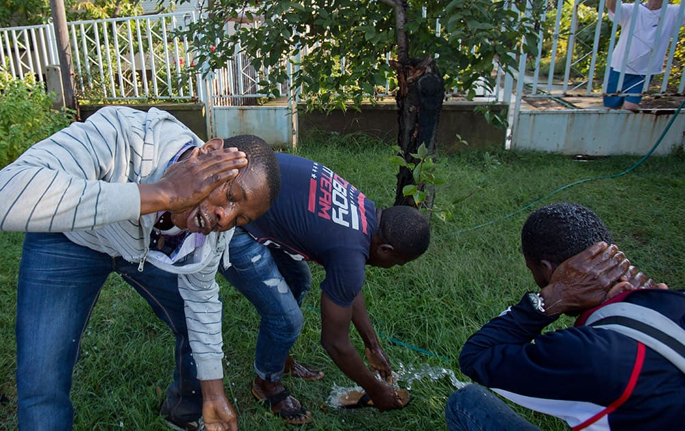 A group of men from Nigeria who crossed from nearby Serbia, refresh themselves in Asotthalom, Hungary.