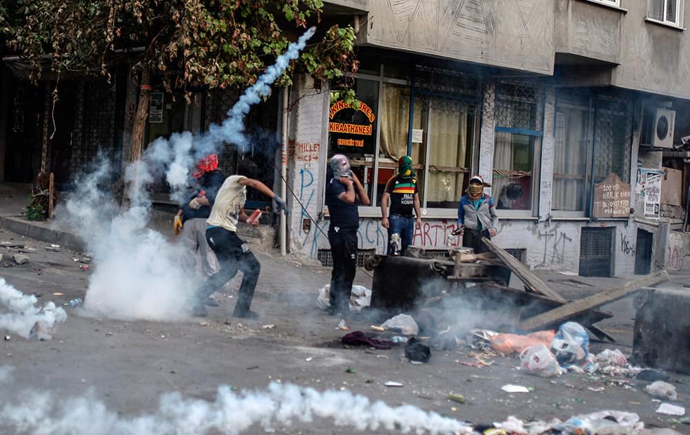 Masked leftist militants clash with security forces during a protest in Gazi district in Istanbul, Turkey.