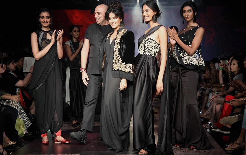 Bollywood actress Chitrangada Singh walks the ramp displaying an outfit by designer Tarun Tahiliani, during the Lakme Fashion Week Winter/ Festive 2015, in Mumbai.