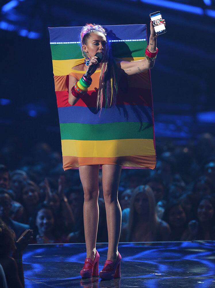 Host Miley Cyrus speaks at the MTV Video Music Awards at the Microsoft Theater.