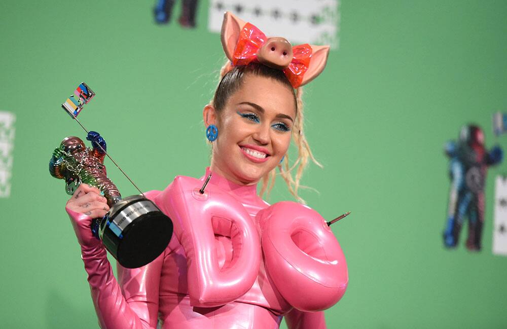 Miley Cyrus poses in the press room at the MTV Video Music Awards at the Microsoft Theater.