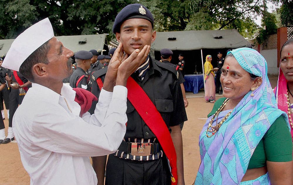 Parents share a happy moment with their son during the Passing Out Parade of 251 ASC recruits at ASC Centre (South) in Bengaluru.
