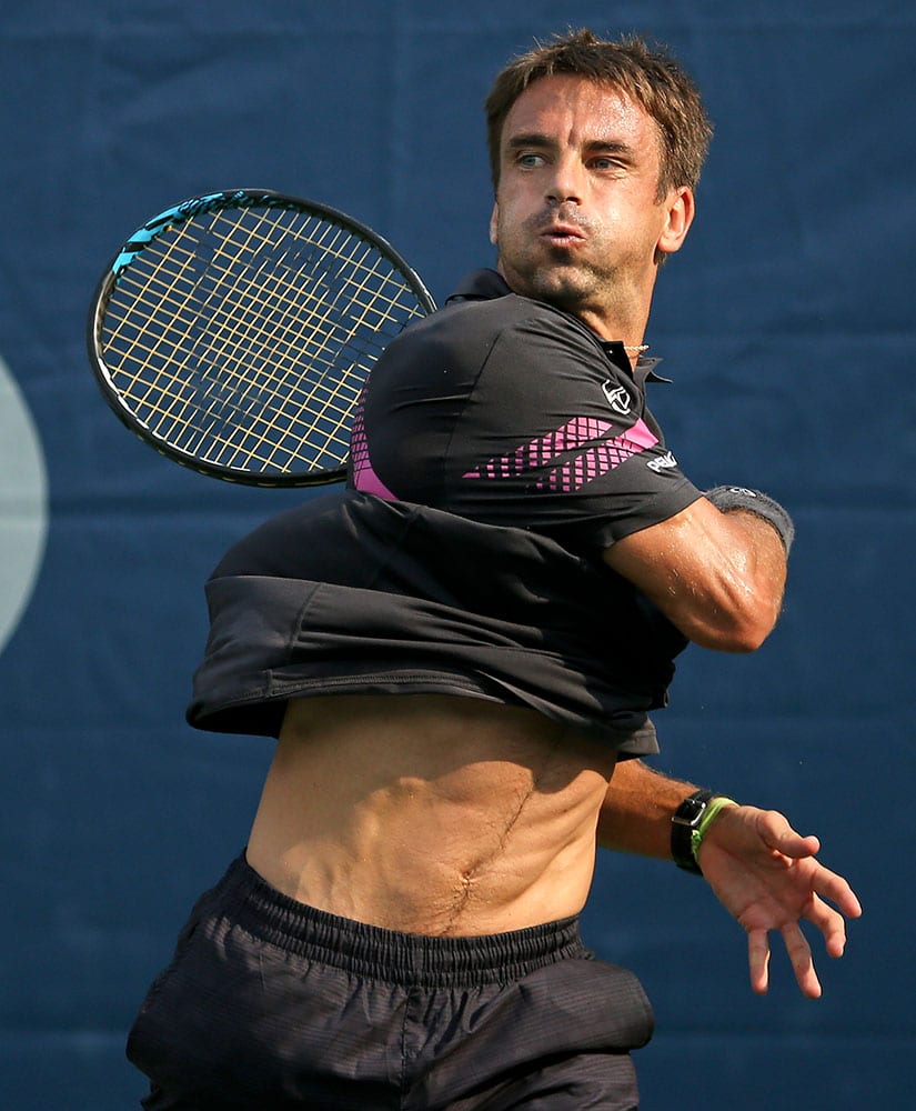 ommy Robredo, of Spain, returns a shot against Michael Berrer, of Germany, during the first round of the U.S. Open tennis tournament in New York. 