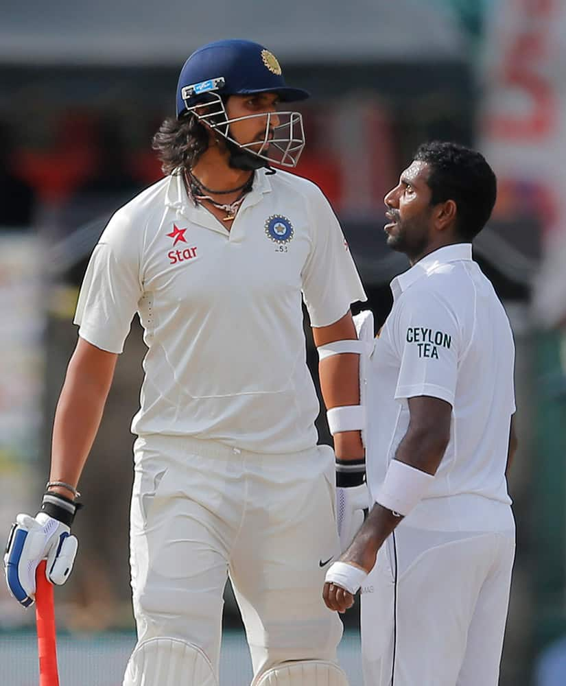 ri Lankan bowler Dhammika Prasad, right and India's Ishant Sharma exchange words on day four of the third test cricket match between them in Colombo, Sri Lanka.