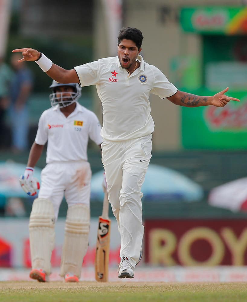 Umesh Yadav celebrates taking the wicket of Sri Lanka's Dimuth Karunarathne, unseen, on day four of the third test cricket match between them in Colombo, Sri Lanka.