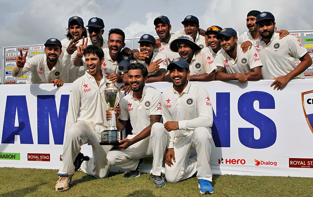 Indian cricketers pose with the trophy after they won the test cricket series against Sri Lanka in Colombo, Sri Lanka. India won the third cricket test match by 117 runs and the series by 2-1.