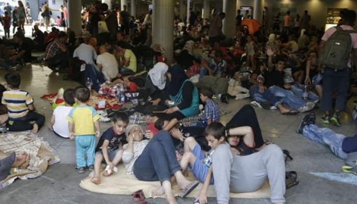 Migrant chaos at Budapest train station; Germany says EU rules still hold