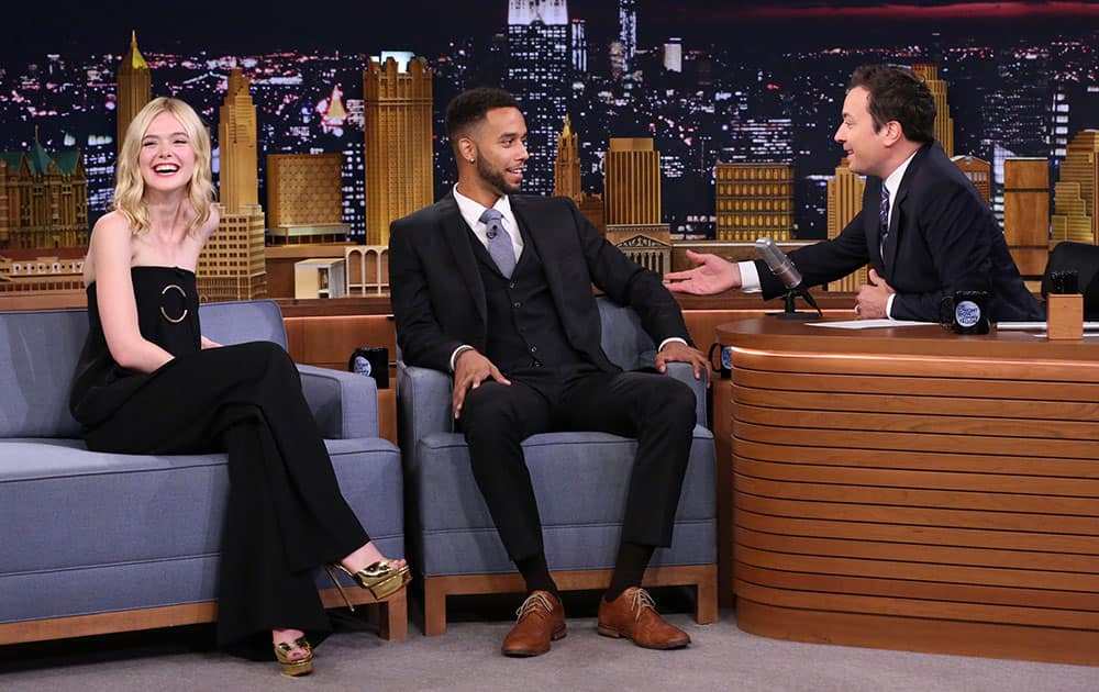 actress Elle Fanning, left, smiles, as host Jimmy Fallon, right, speaks with Anthony Sadler during a taping of 