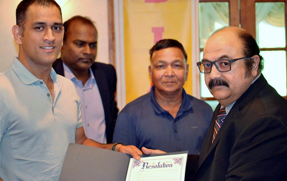 Mahendra Singh Dhoni being honored with a resolution at a reception organized in New Jersey by Bihar Jharkhand Association of North America recently.