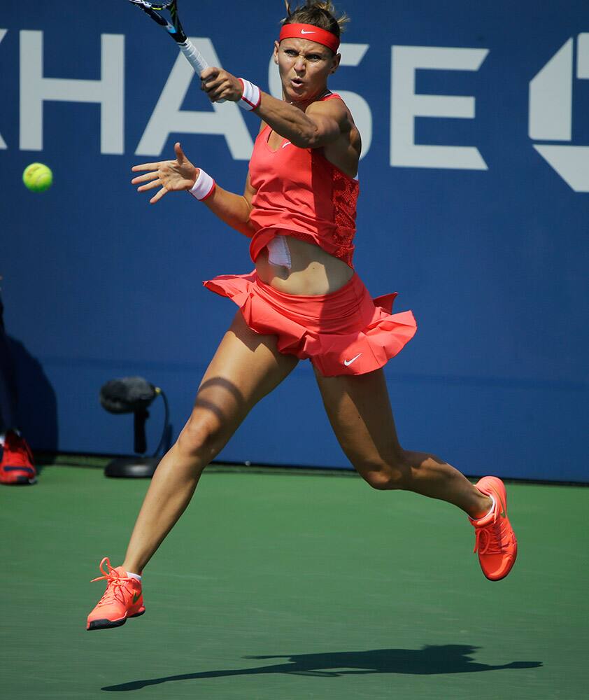 Lucie Safarova, of the Czech Republic, returns a shot to Lesia Tsurenko, of Ukraine, during the first round of the US Open tennis tournament.