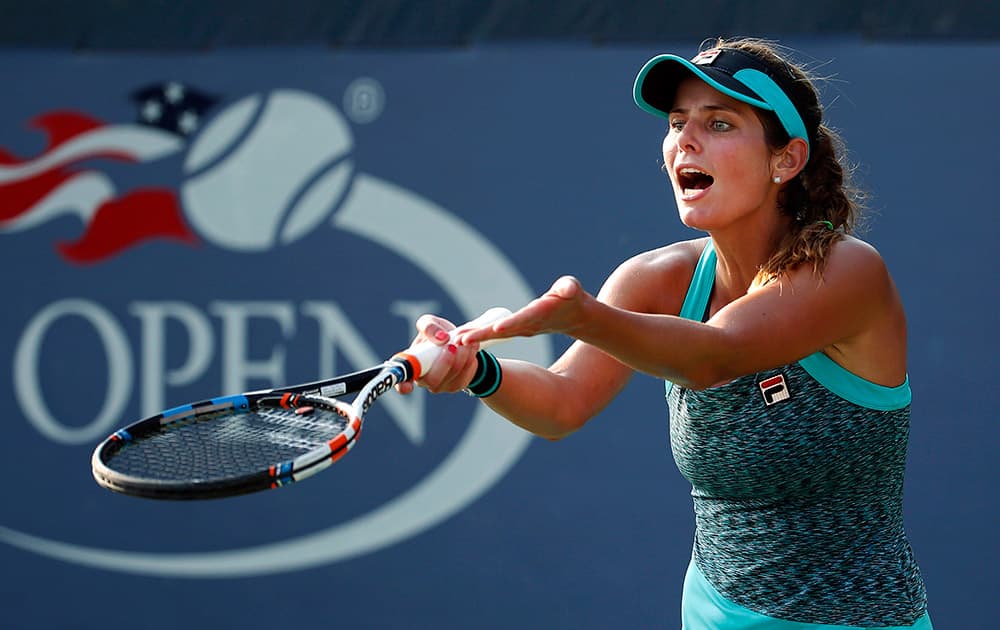 Julia Goerges, of Germany, argues a call in her match against Anna Schmiedlova, of Slovakia, during the first round of the US Open tennis tournament.