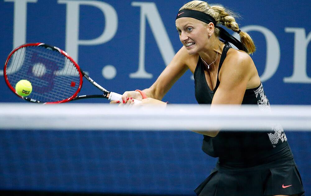 Petra Kvitova, of the Czech Republic, returns a shot to Laura Siegemund, of Germany, during the first round of the US Open tennis tournament in New York.