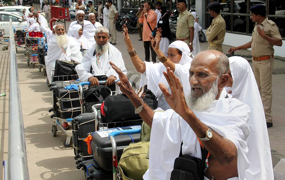 Haj pilgrims wave to relatives as they wait to depart for Mecca, at Sardar Sardar Vallabhbhai Patel International Airport in Ahmedabad.