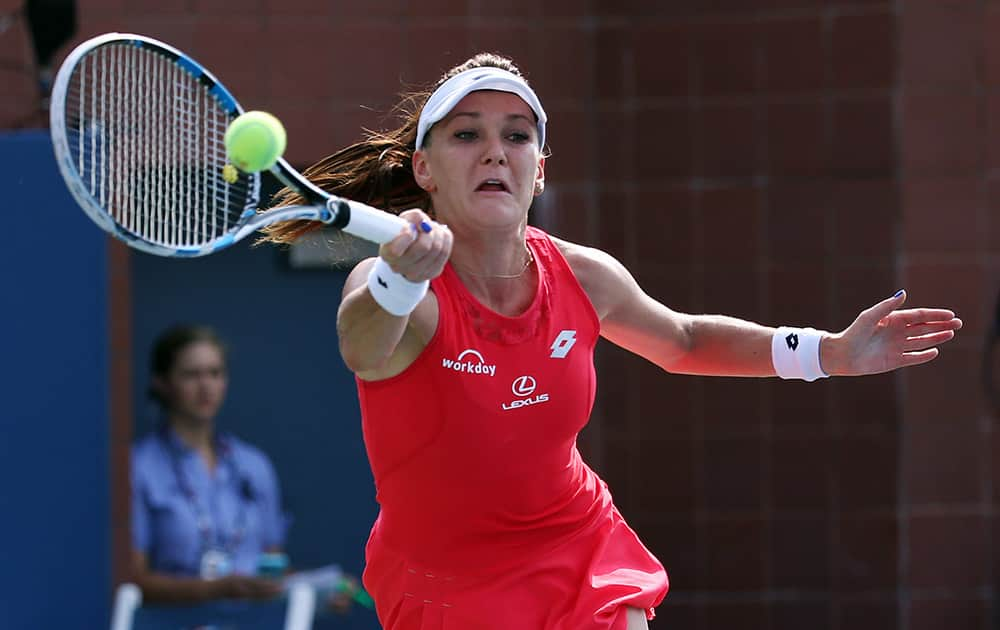 Agnieszka Radwanska, of Poland, returns a shot to Magda Linette, of Poland, during the second round of the US Open tennis tournament.