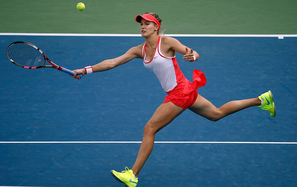 Eugenie Bouchard, of Canada, returns a shot to Polona Hercog, of Slovenia, during the second round of the US Open tennis tournament.