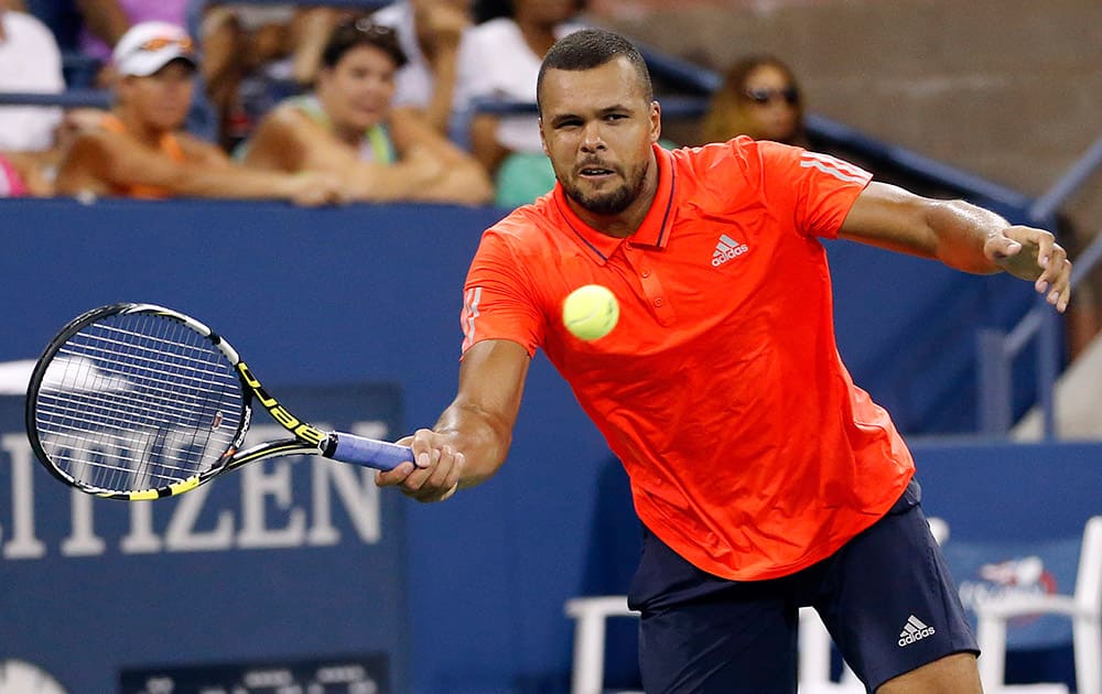 Jo-Wilfried Tsonga, of France, hits a forehand to Marcel Granollers, of Spain, during the second round of the US Open tennis tournament in New York.