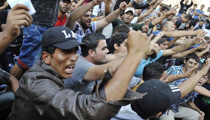 Migrants storm Budapest train as horror of crisis hits home