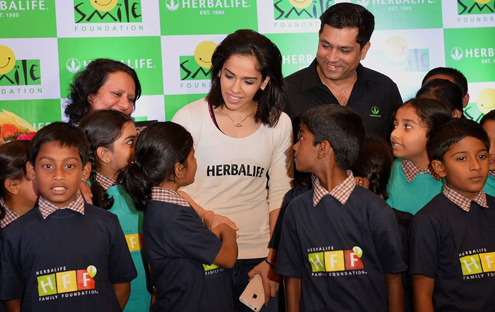 Badminton star Saina Nehwal interacts with school kids during the launch of third phase of CASA Herbalife programme with Smile Foundation in Bengaluru.