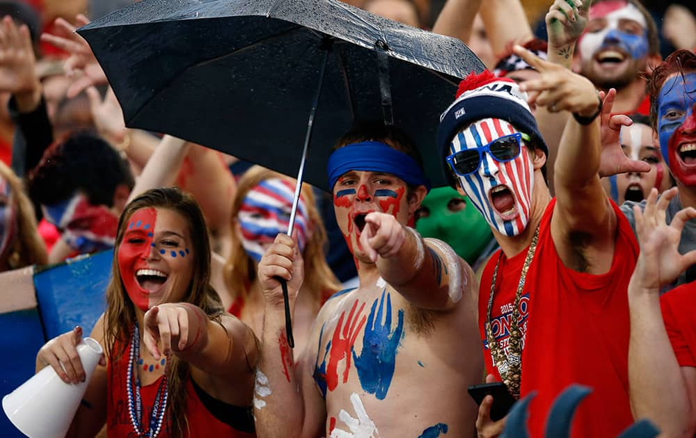 Arizona fans cheer before an NCAA college football game against UTSA, in Tucson, Ariz.