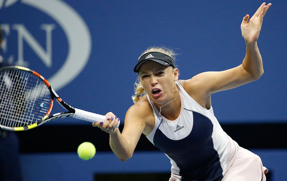 Caroline Wozniacki, of Denmark, returns a shot to Petra Cetkovska, of the Czech Republic, during the second round of the U.S. Open tennis tournament in New York.