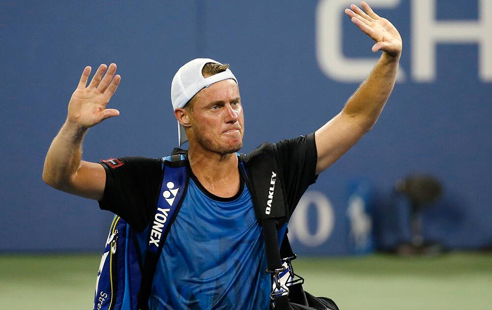 Lleyton Hewitt, of Australia, bids farewell to the crowd after losing to countryman Bernard Tomic, 6-3, 6-2, 3-6, 5-7, 7-5, during the second round of the U.S. Open tennis tournament in New York.