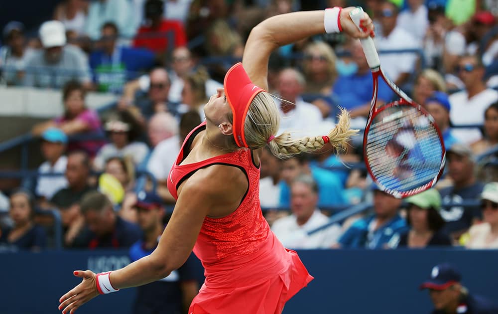 Sabine Lisicki, of Germany, serves to Camila Giorgi, of Italy, during the second round of the U.S. Open tennis tournament.