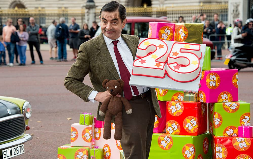 British actor Rowan Atkinson, dressed as Mr Bean poses for photographers outside Buckingham Palace, London, to promote the 25th anniversary of Mr Bean, London.