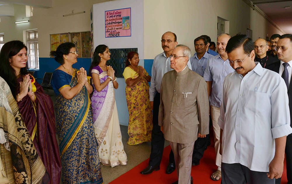 President Pranab Mukherjee with Delhi Chief Minister Arvind Kejriwal arrives to teach students at a Government School on the occasion of Teachers Day in New Delhi.