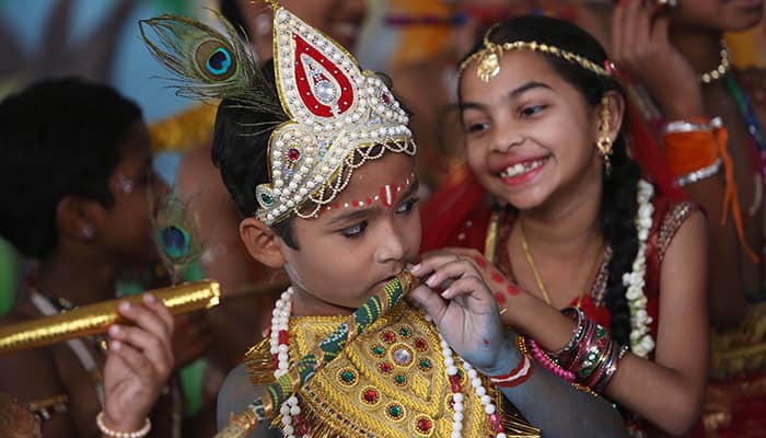 School children dressed as Hindu God Krishna and his consort Radha participate in a fancy dress competition on Janmashthmi in Hyderabad.