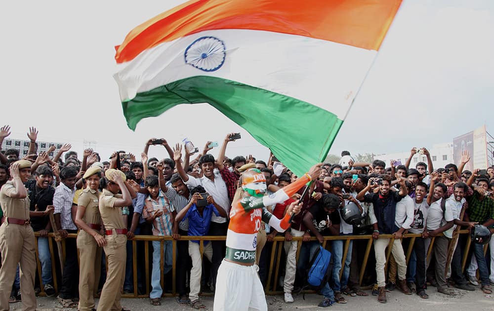 A fan waves a Tricolour during the Isha Gramothsavam, a rural revitalization programme that was attended by cricket legend Sachin Tendulkar in Coimbatore.