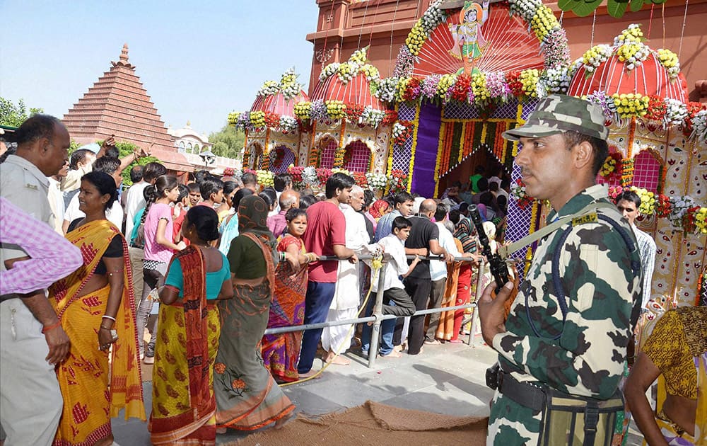 Devotees wait in queues to offer prayers at Sri Krishna Janambhoomi temple on the occasion of Janmashtami festival in Mathura.