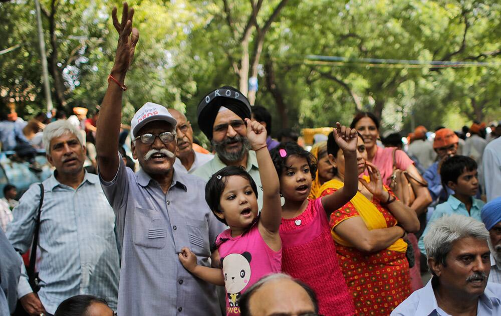 Ex-servicemen and children shout slogans during a protest in New Delhi.