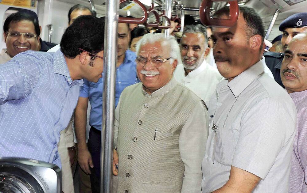 Haryana Chief Minister Manohar Lal Khattar rides a metro train in Faridabad.