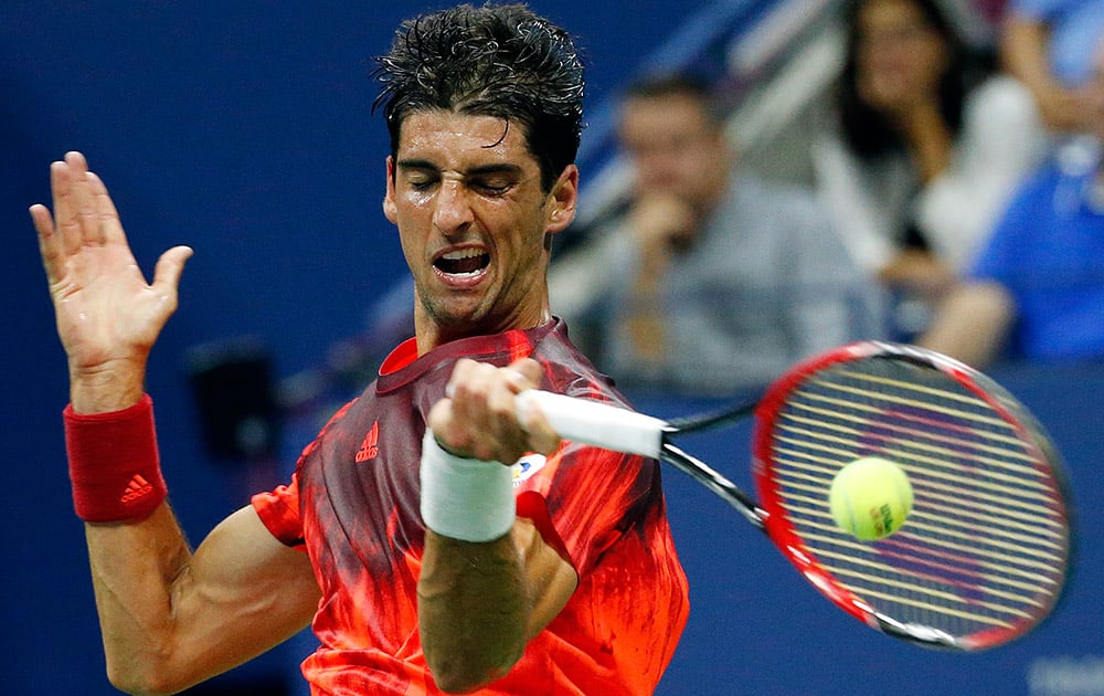 Thomaz Bellucci, of Brazil, returns a shot to Andy Murray, of Britain, during the third round of the U.S. Open tennis tournament in New York.