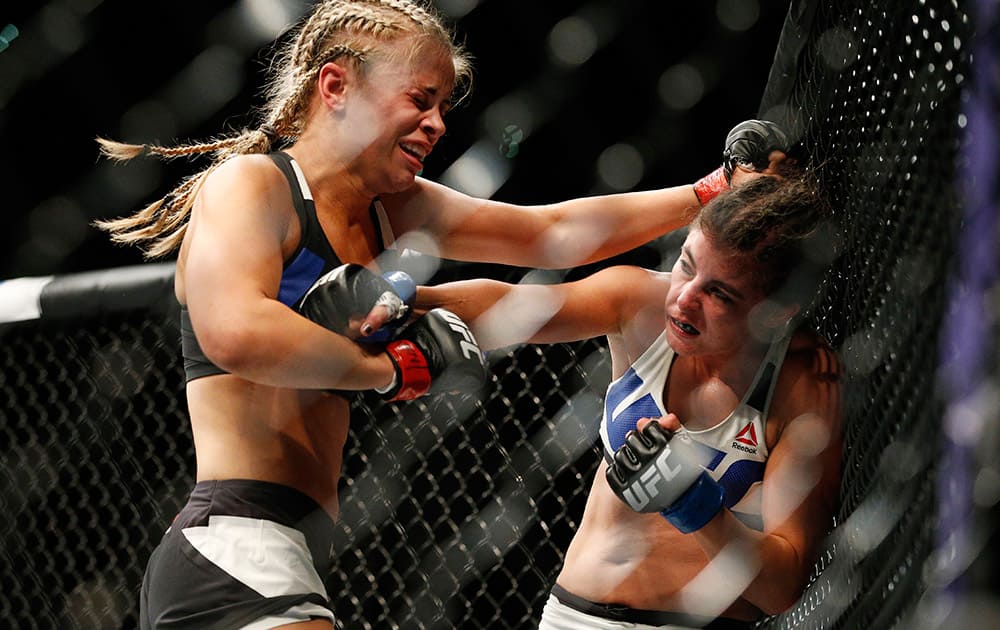 Paige VanZant, left, fights Alex Chambers during their women’s straw weight mixed martial arts bout at UFC 191 in Las Vegas.