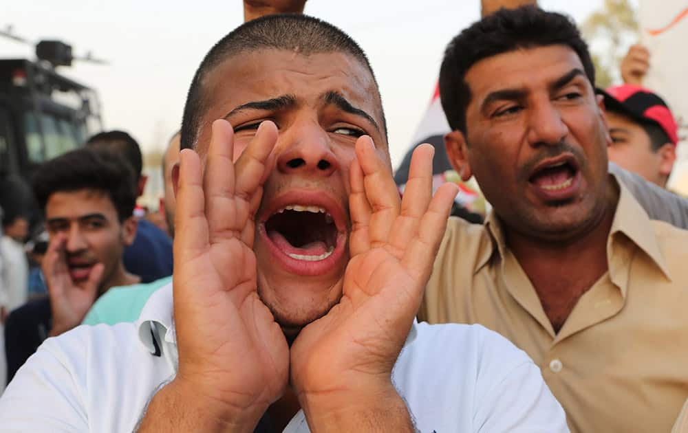 Protesters chant slogans during a demonstration against corruption in Basra, 340 miles (550 kilometers) southeast of Baghdad, Iraq.