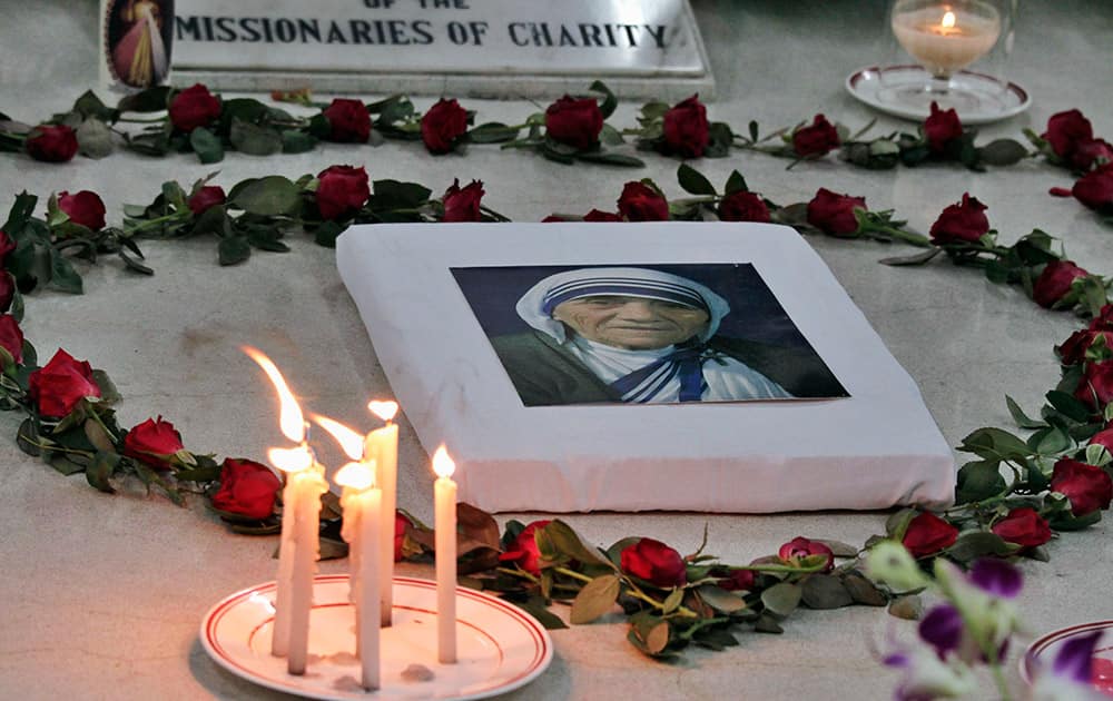 A portrait of Mother Teresa, the founder of the Missionaries of Charity, is placed on her tomb during a prayer ceremony to mark the anniversary of her death in Kolkata, India.