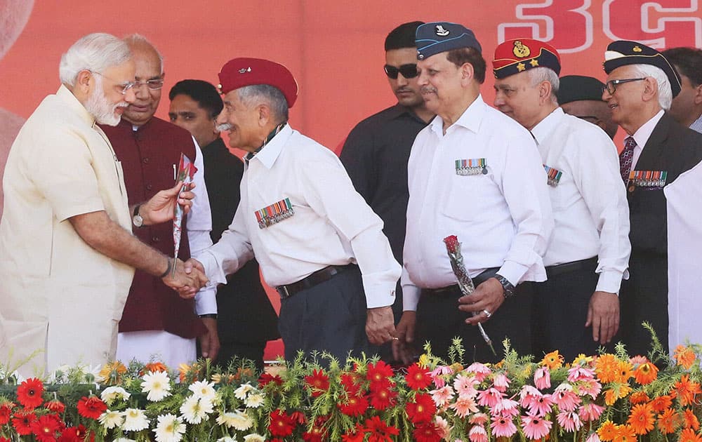 Prime Minister Narendra Modi is greeted by Ex-Servicemen during the inauguration of Badarpur-Faridabad extension of the Delhi Metro in Faridabad.