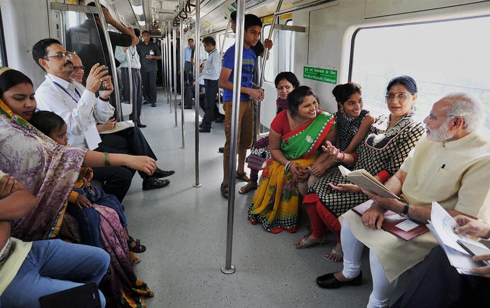 Prime Minister Narendra Modi interacting with the co-passengers while travelling by the Delhi Metro to Faridabad.