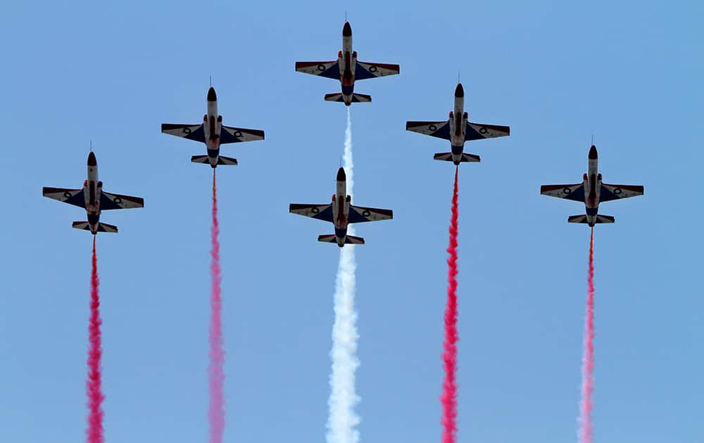 Pakistan Air Force fighter jets demonstrate an aerobatic maneuver during a ceremony to mark Pakistani Defense Day, in Islamabad.